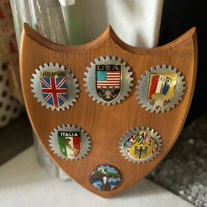 Warm Wooden Shield Wall Decor with Emblems and Metallic Accents